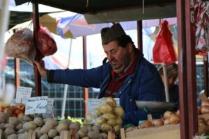 A man selling produce at a local market in Vracar.